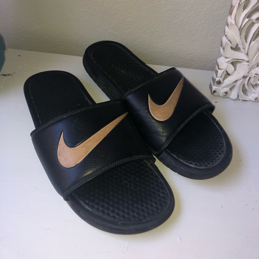 Men’s black and gold swish Nike slides